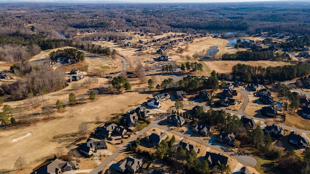 bird's eye view with a wooded view