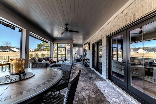 sunroom featuring wooden ceiling, ceiling fan, and french doors