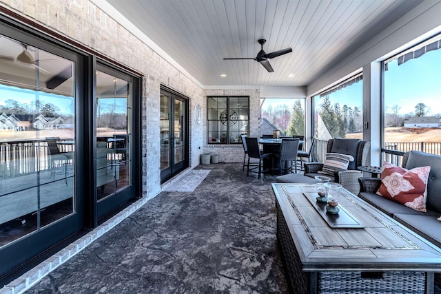 sunroom with wood ceiling and ceiling fan