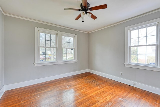 unfurnished room featuring light wood-type flooring, crown molding, and baseboards