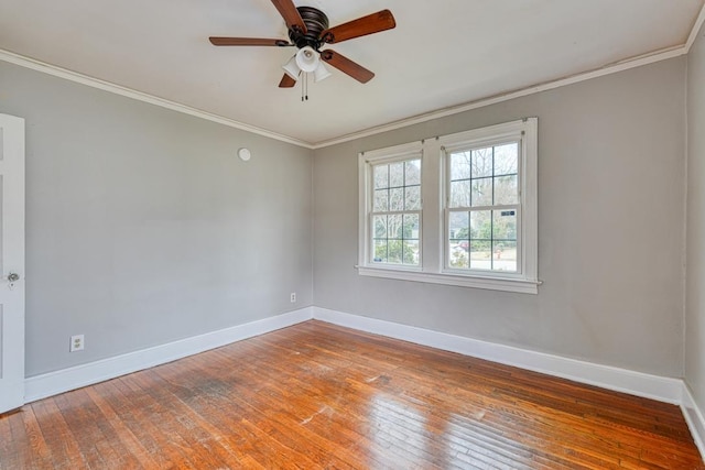 spare room with ceiling fan, baseboards, ornamental molding, and wood-type flooring