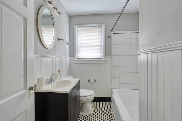 full bathroom featuring shower / bathtub combination, wainscoting, vanity, and toilet