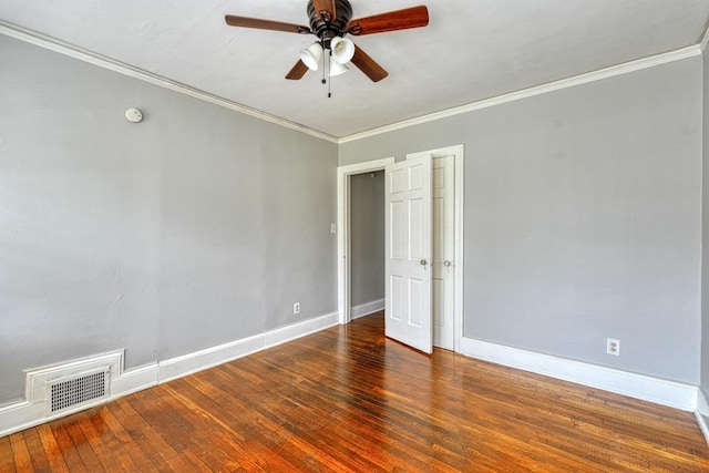 empty room featuring visible vents, ornamental molding, a ceiling fan, baseboards, and hardwood / wood-style flooring