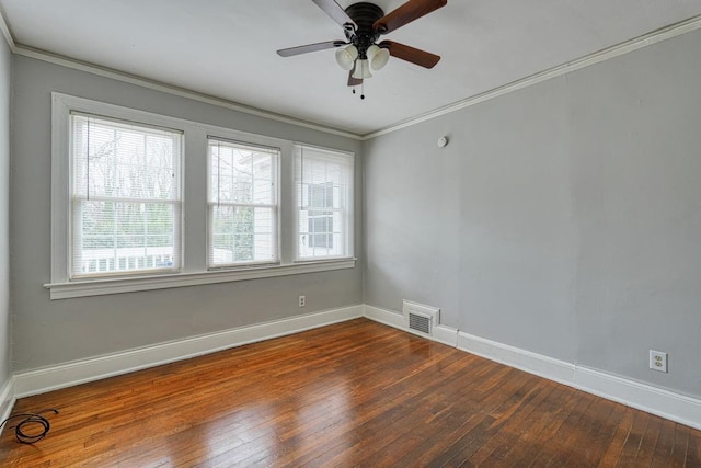 spare room featuring hardwood / wood-style flooring, visible vents, and ornamental molding