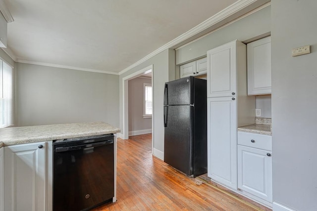 kitchen featuring light wood-style flooring, baseboards, light countertops, ornamental molding, and black appliances