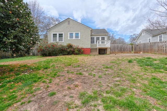 rear view of property with a fenced backyard