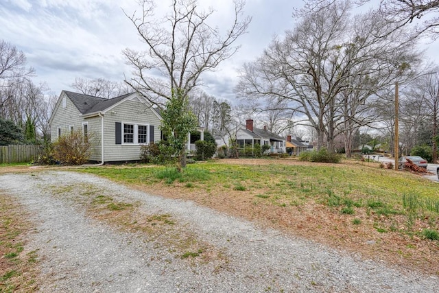 view of front of home with driveway and fence