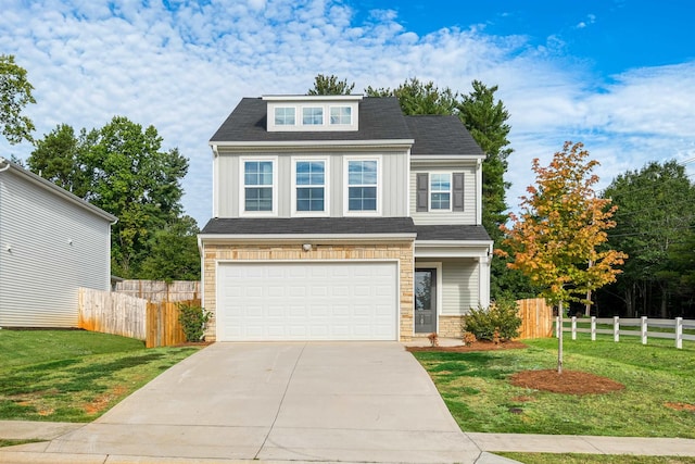 view of front of home with a front lawn, concrete driveway, fence, and an attached garage