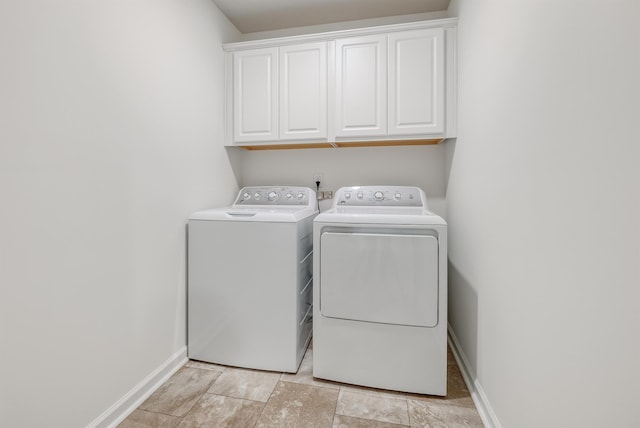 washroom featuring cabinet space, baseboards, and independent washer and dryer