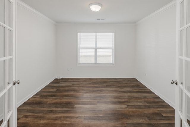 spare room with french doors, dark wood finished floors, and crown molding