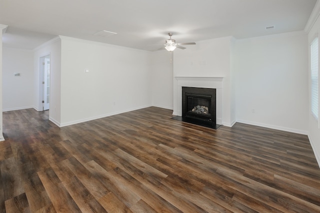 unfurnished living room featuring baseboards, a fireplace with flush hearth, dark wood finished floors, and crown molding