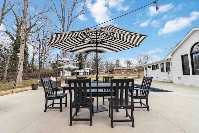 view of patio featuring outdoor dining area and fence