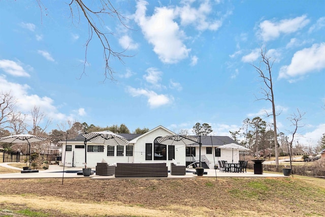 back of property featuring a patio and an outdoor hangout area