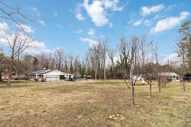 view of yard featuring a garage and fence