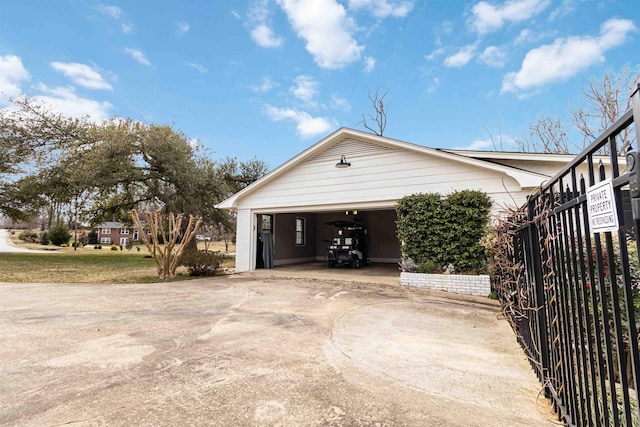 view of side of property with a detached garage and fence