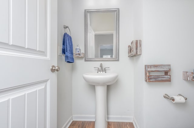 bathroom featuring baseboards and wood finished floors