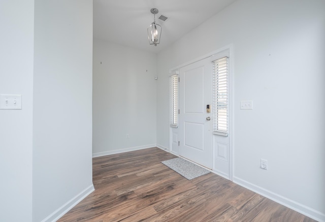 foyer entrance featuring baseboards and dark wood-style flooring