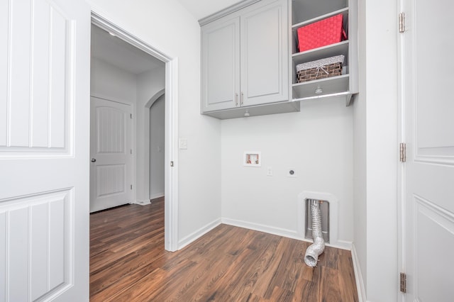 laundry area with arched walkways, washer hookup, cabinet space, dark wood finished floors, and electric dryer hookup