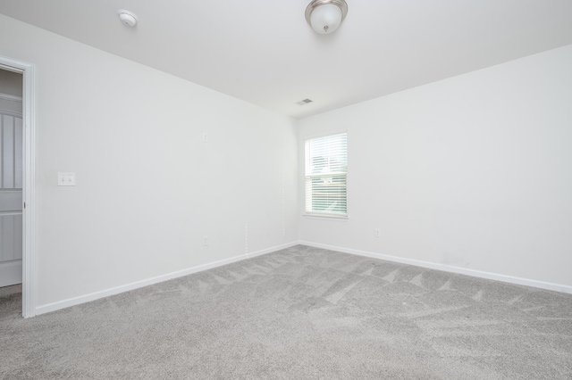 carpeted spare room with baseboards