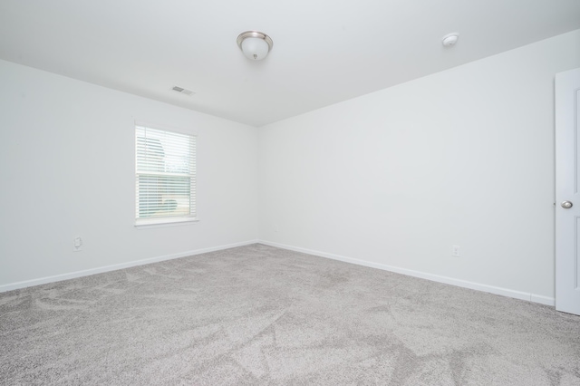 spare room with carpet and baseboards