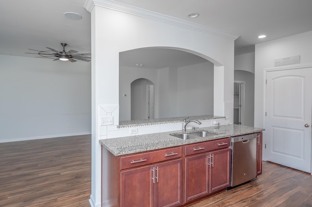 kitchen featuring reddish brown cabinets, dark wood-style flooring, stainless steel dishwasher, a sink, and ceiling fan