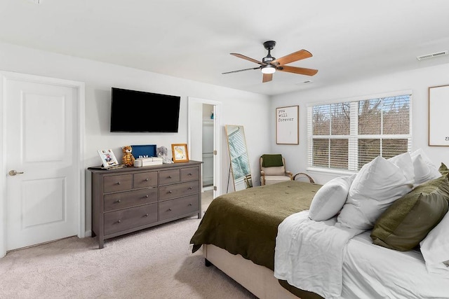 bedroom featuring light carpet, ceiling fan, and visible vents