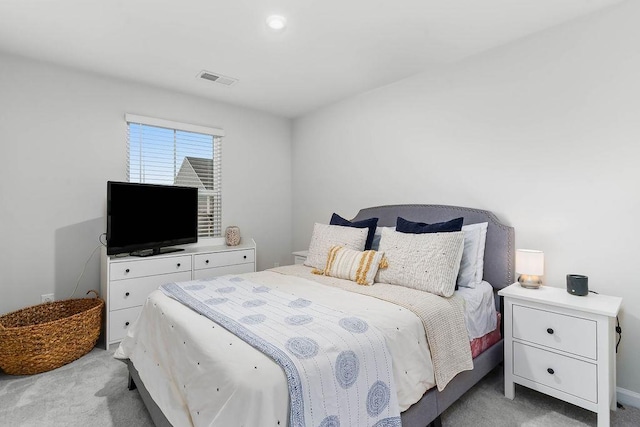 bedroom with light carpet and visible vents