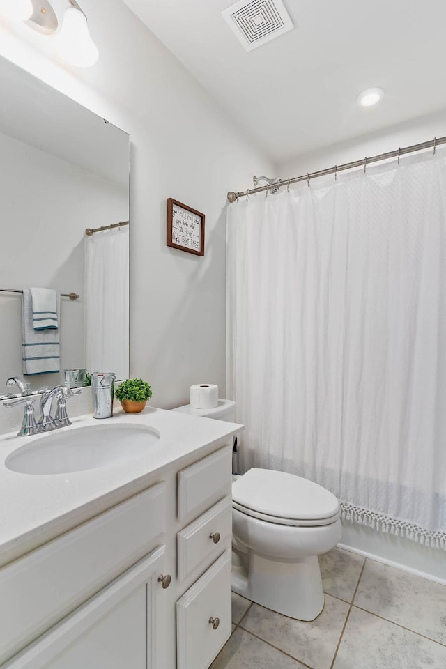 bathroom with a shower with curtain, visible vents, toilet, vanity, and tile patterned flooring