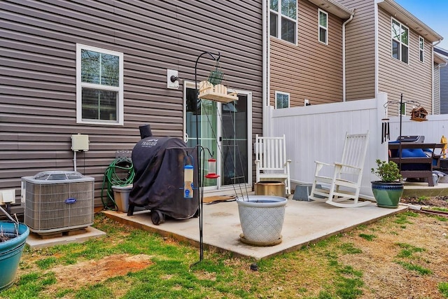 view of patio featuring cooling unit, fence, and area for grilling