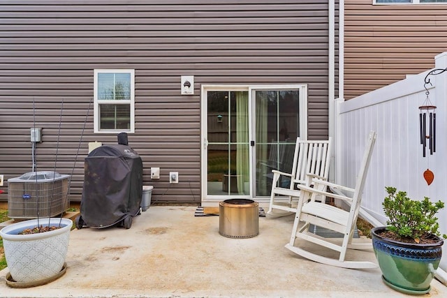 view of patio with central AC unit and a grill