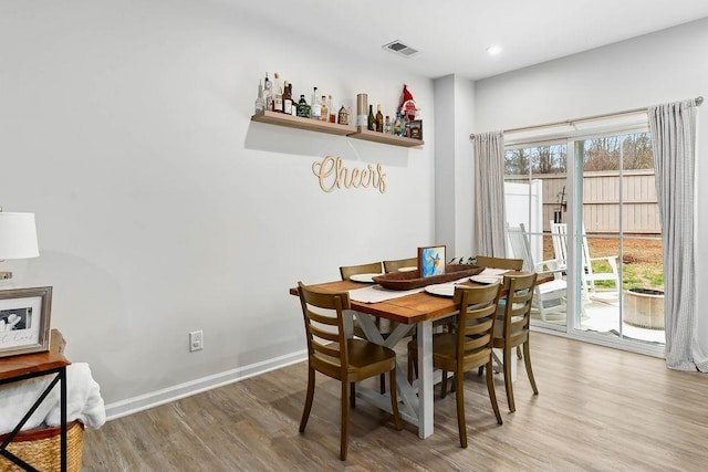 dining space with recessed lighting, visible vents, light wood-style flooring, and baseboards