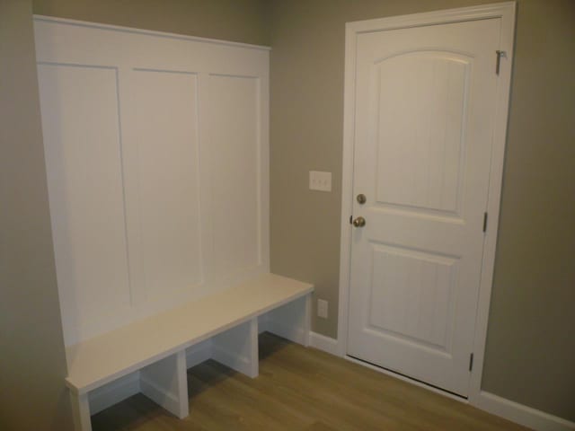 mudroom featuring baseboards and wood finished floors