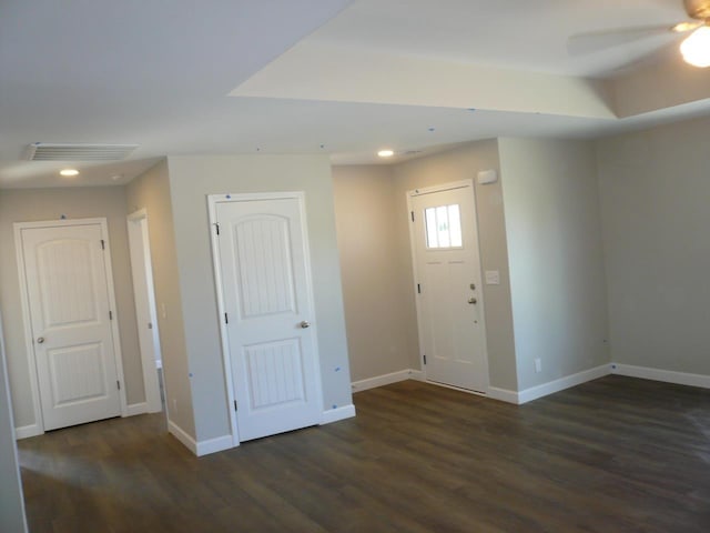 foyer featuring visible vents, baseboards, and wood finished floors