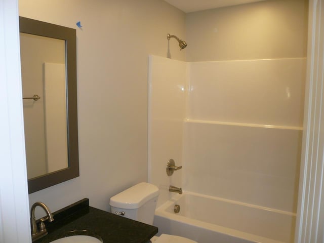 bathroom with toilet, vanity, and shower / bathtub combination