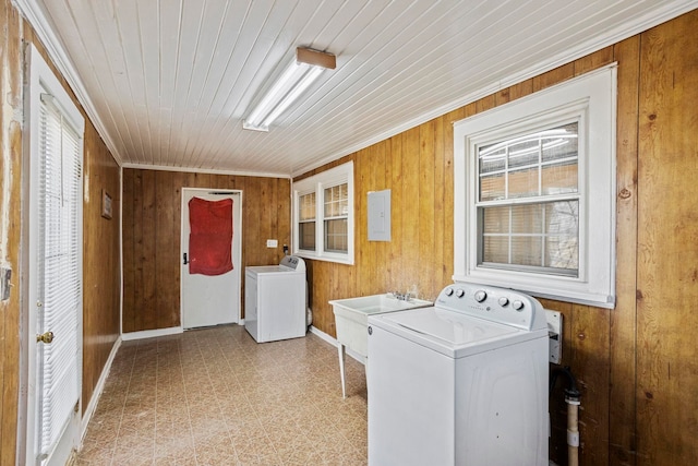 washroom with laundry area, wood walls, and washer / dryer