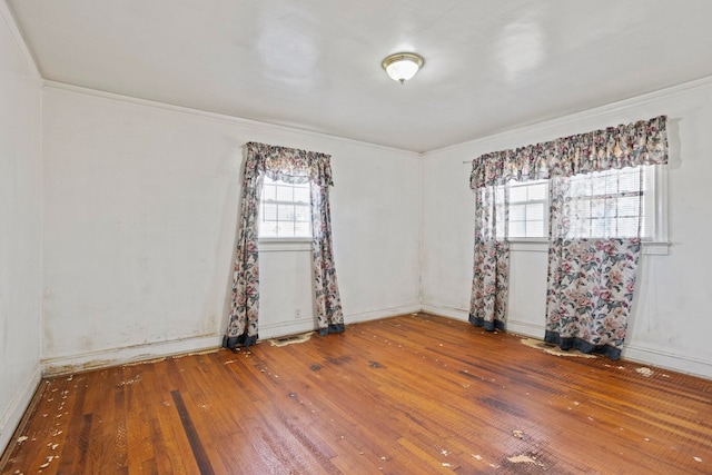 unfurnished room featuring wood-type flooring and visible vents