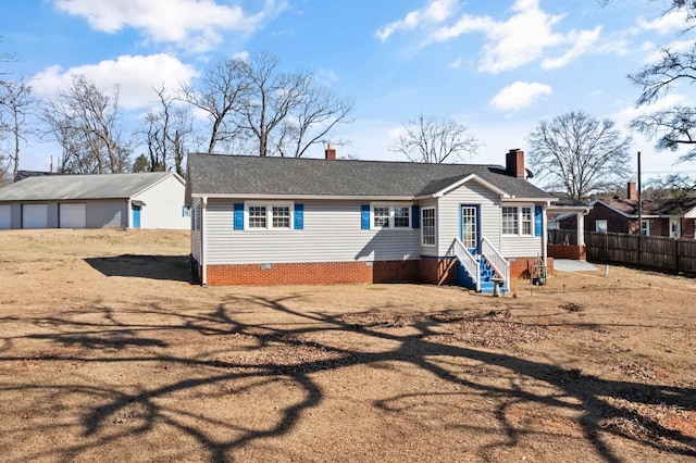 view of front of property featuring an outbuilding, crawl space, roof with shingles, and fence