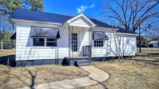 view of front facade featuring crawl space and metal roof