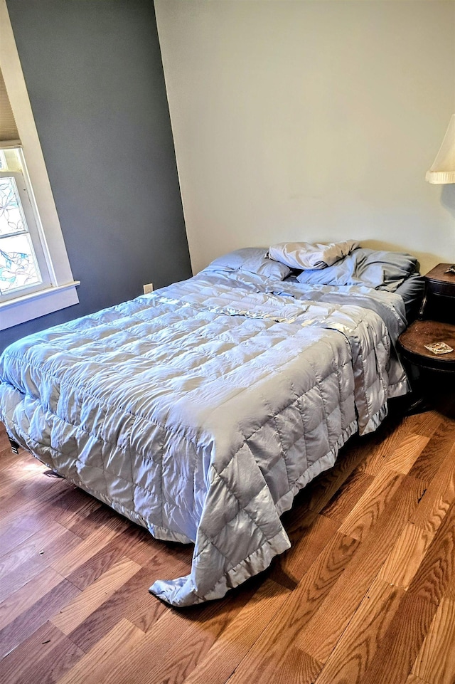 bedroom featuring wood finished floors