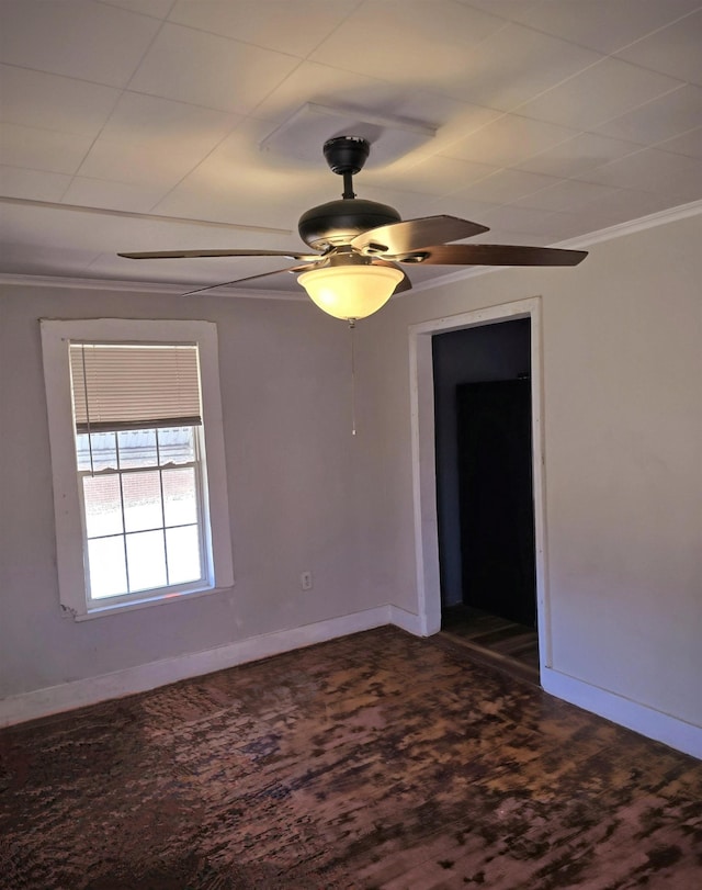 spare room with a ceiling fan, baseboards, and crown molding