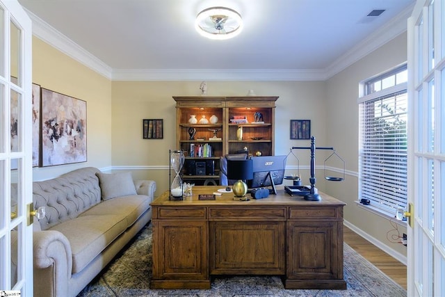 office with ornamental molding, visible vents, baseboards, and wood finished floors