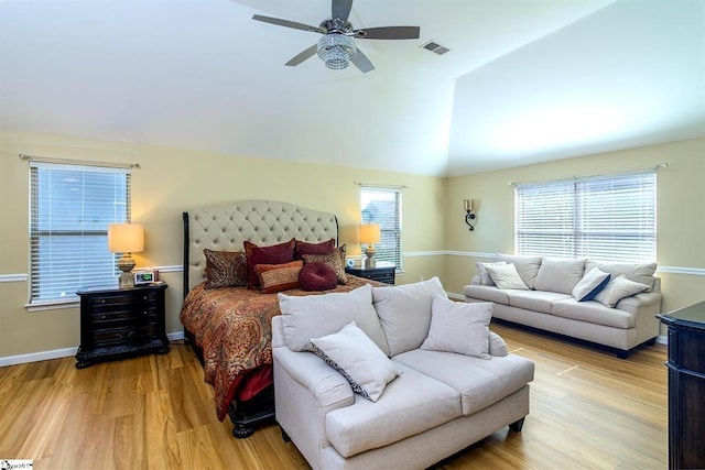 bedroom featuring a ceiling fan, baseboards, vaulted ceiling, visible vents, and light wood-style floors