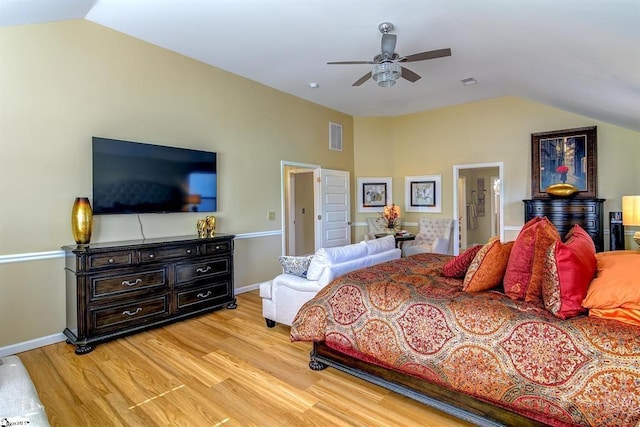 bedroom featuring lofted ceiling, baseboards, visible vents, and wood finished floors