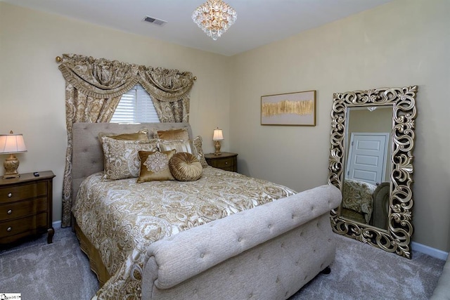 bedroom featuring carpet floors, visible vents, baseboards, and an inviting chandelier