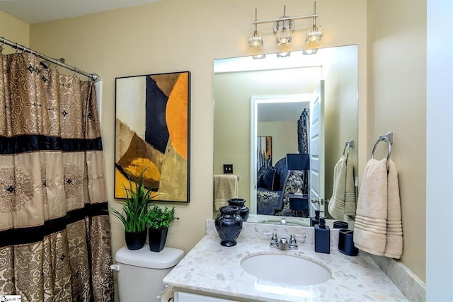 bathroom with toilet, curtained shower, and vanity