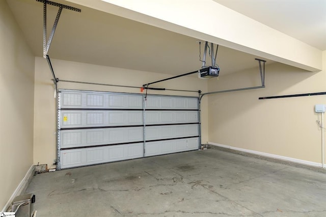 garage featuring baseboards and a garage door opener