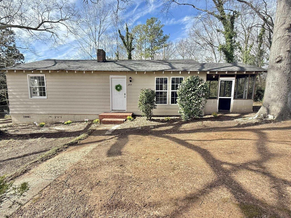 view of front facade featuring crawl space and a chimney