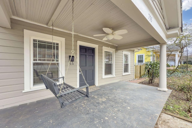 view of exterior entry with covered porch and ceiling fan