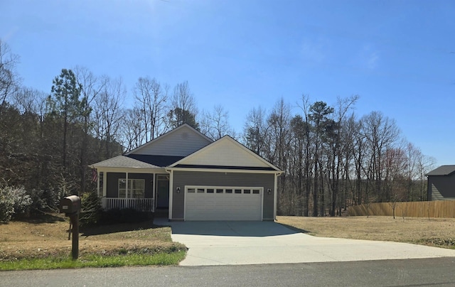 view of front of house featuring a garage, covered porch, fence, and concrete driveway