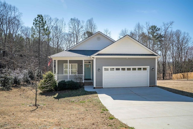 view of front facade featuring a garage, driveway, and covered porch